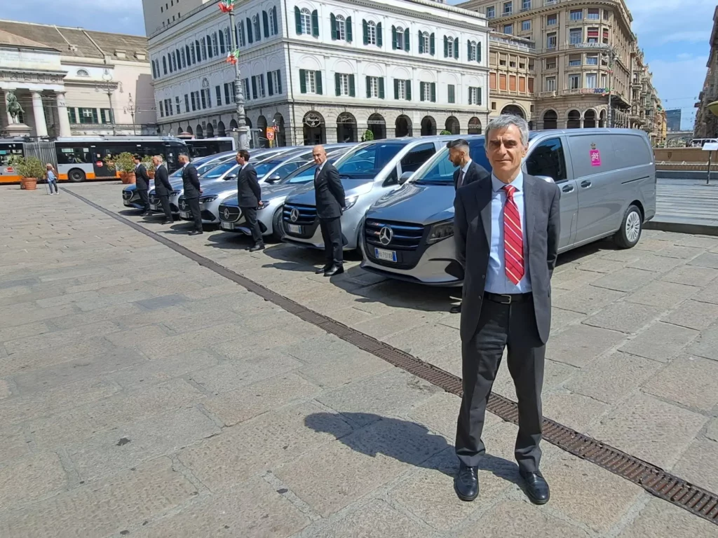 Rappresentante A.Se.F. davanti alla nuova flotta aziendale in piazza De Ferrari a Genova.