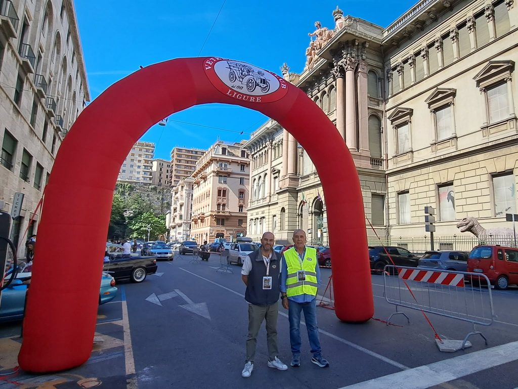 Due organizzatori posano sotto l’arco del Veteran Car Club Ligure durante il Terzo Meeting del Museo.